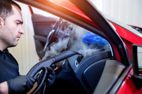 car-service-worker-cleans-interiror-with-steam-cleaner(1)